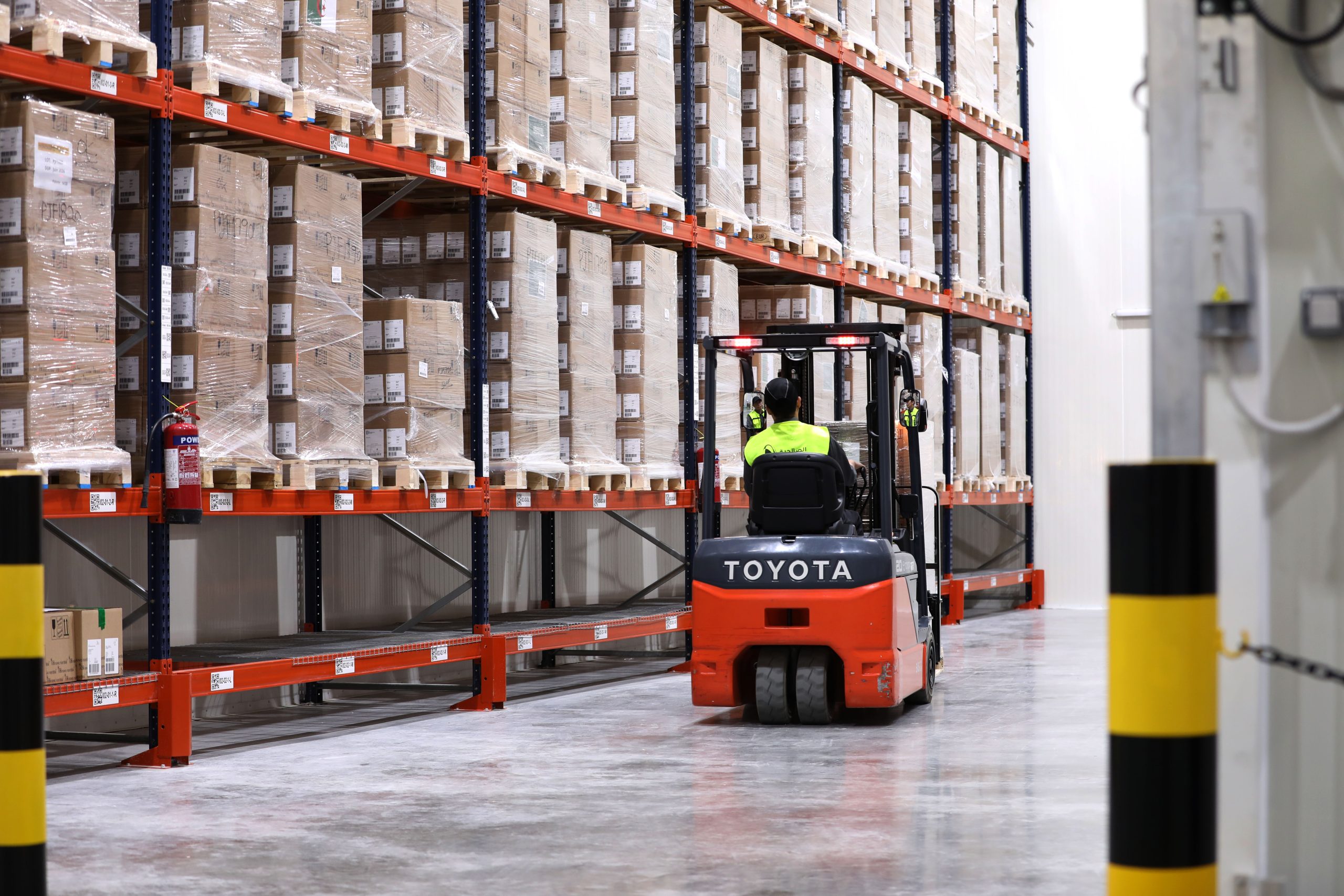 Forklift moving pallets through the cold chain warehouse racking at the Regional Distribution Center